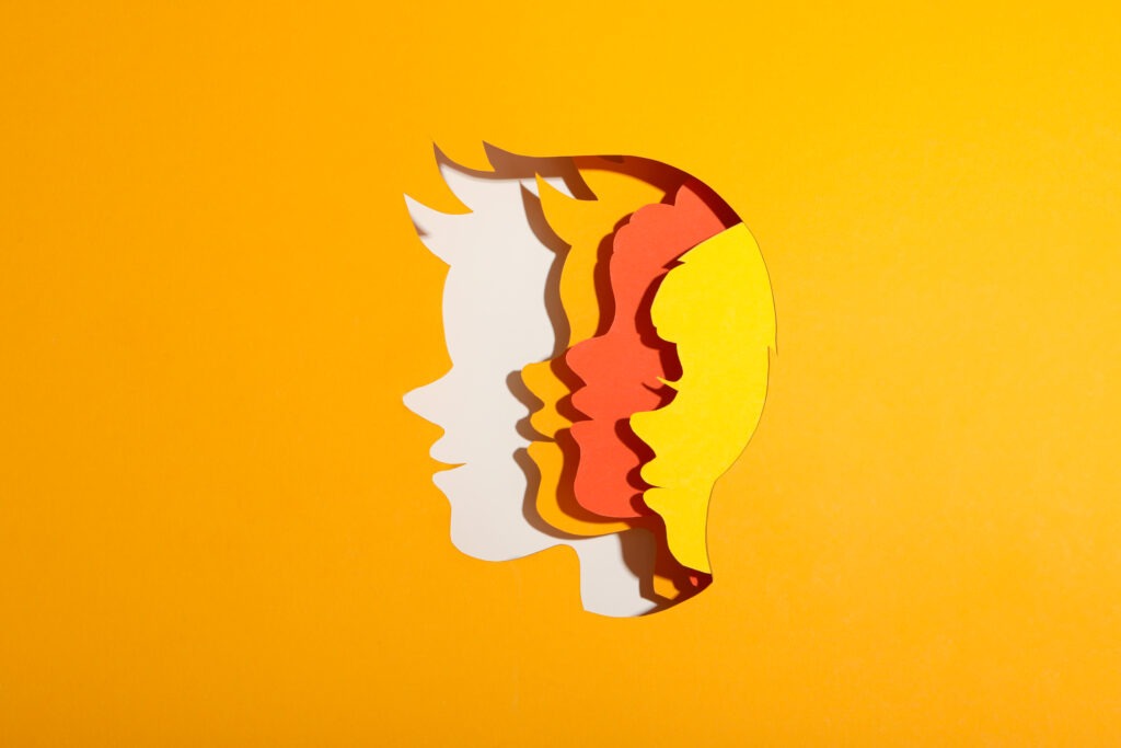 Children's heads made of paper on a yellow background